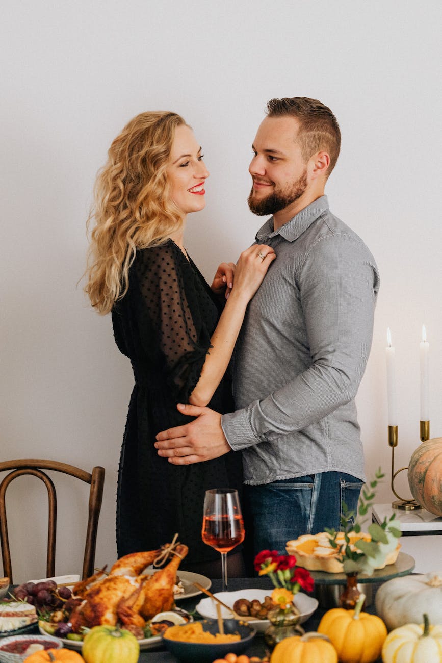 couple hugging near table at thanksgiving dinner