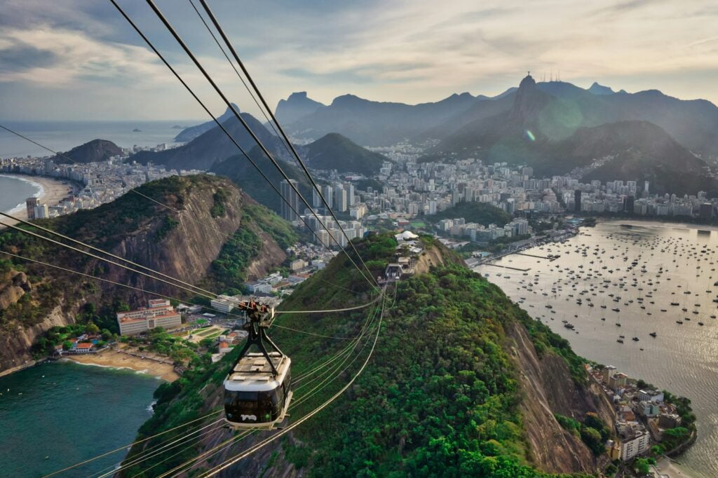 cable cars over the green grass field - things to do in south america