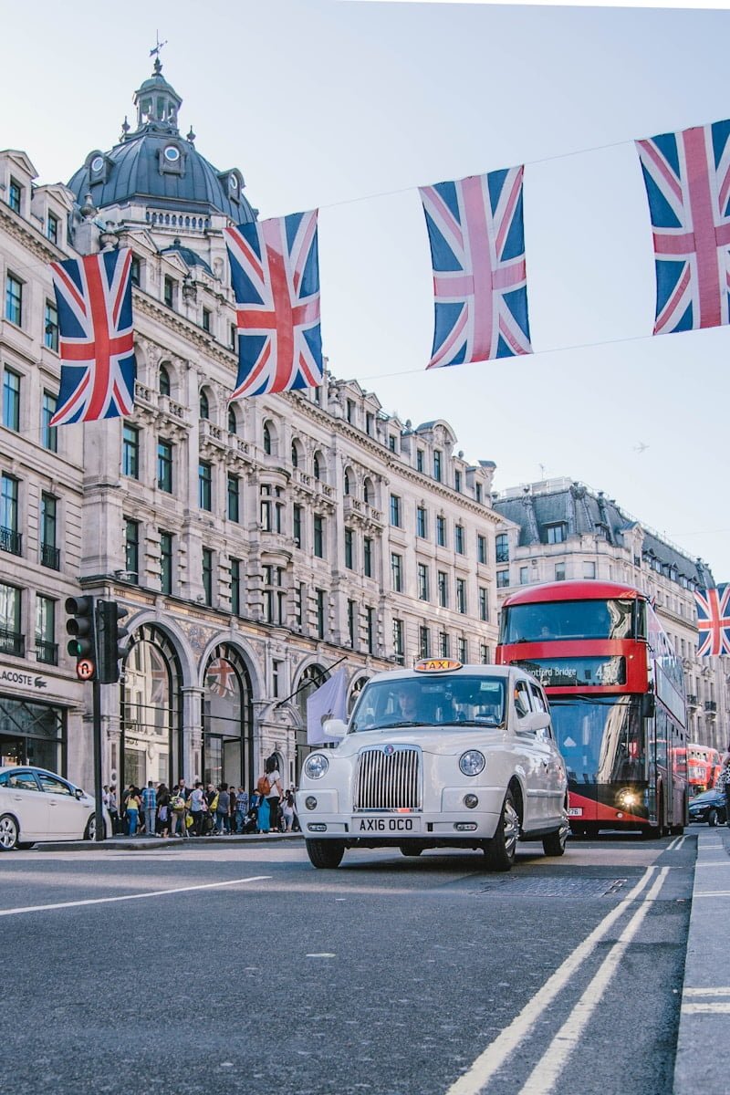 photo of car and bus near castle - BEST HOSTELS IN LONDON