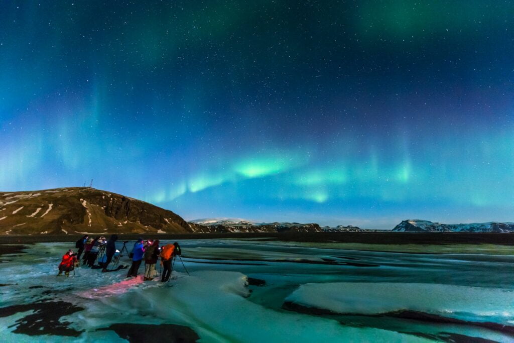 people on beach during night time - Future Cityscape • The Solo Travel Guide (Ideas & Tips)