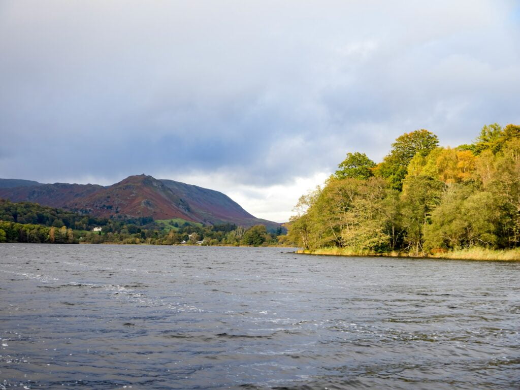 a body of water with a mountain in the background