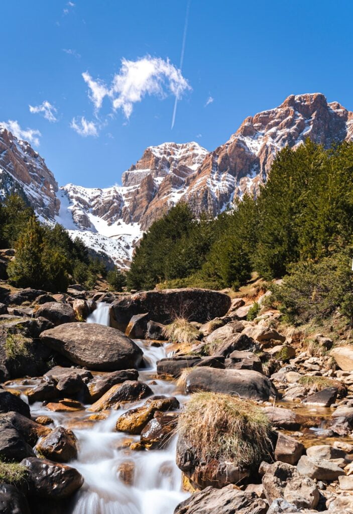 green trees near rocky mountain under blue sky during daytime - Outdoor Activities in Spain