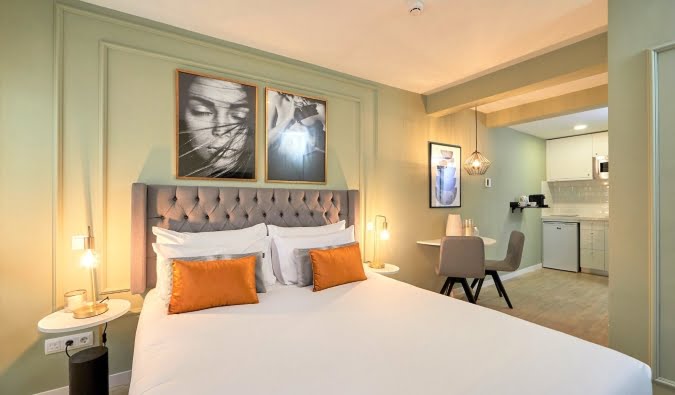 Stay at Best Hotels in Madrid - L&H La Latina and enjoy a comfortable room with bed, TV, and kitchen.