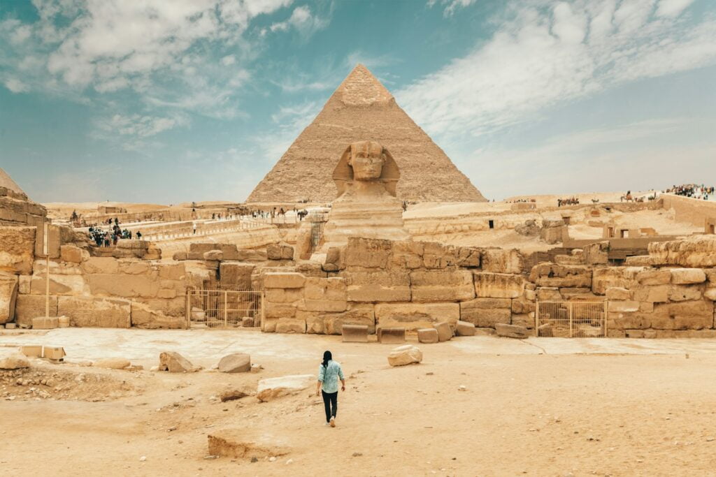 person walking near The Great Sphinx - things to do in cairo (Pyramids of Giza)