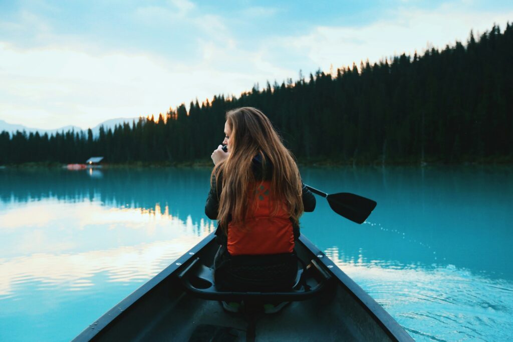 blonde haired woman riding on boat - family activities in Canada