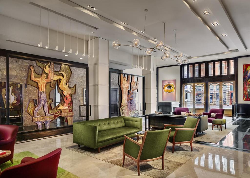 The vibrant lobby of The Joule, Dallas hotel, featuring colorful furniture and a welcoming ambiance.