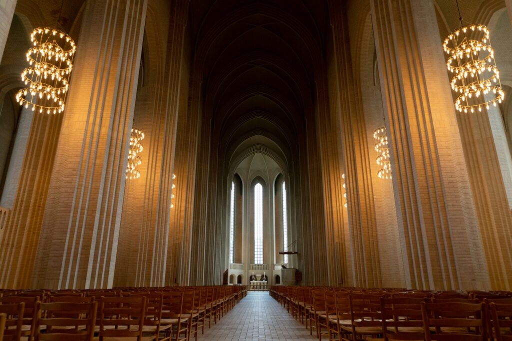 a large church with rows of chairs - Grundtvig’s Church one of Best Things to Do in Copenhagen