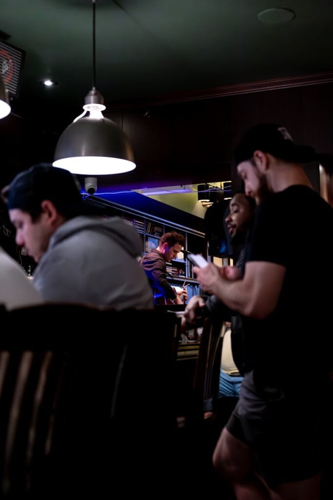 a group of people sitting at a table in a Bars and Pubs, Things to Do in Toronto