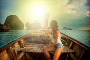 Woman Wearing White Tank Top Seating on Boat