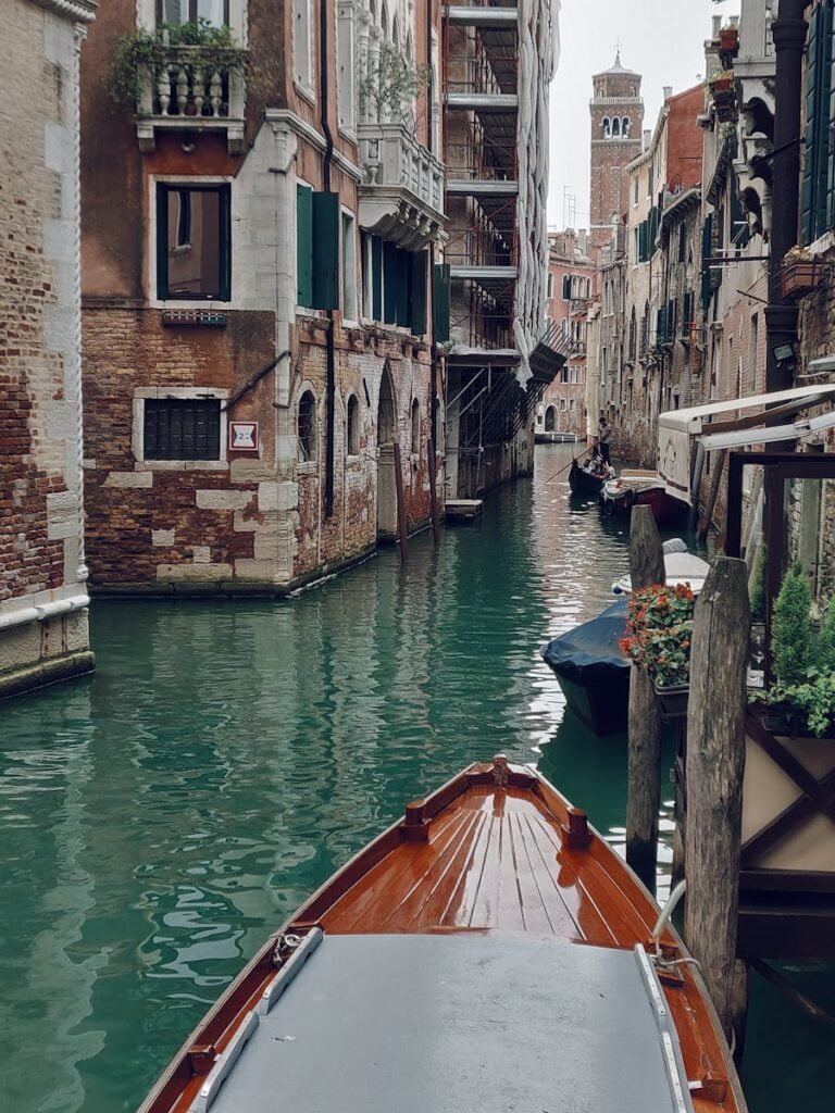 Brown Boat Along The Canals Of Venice