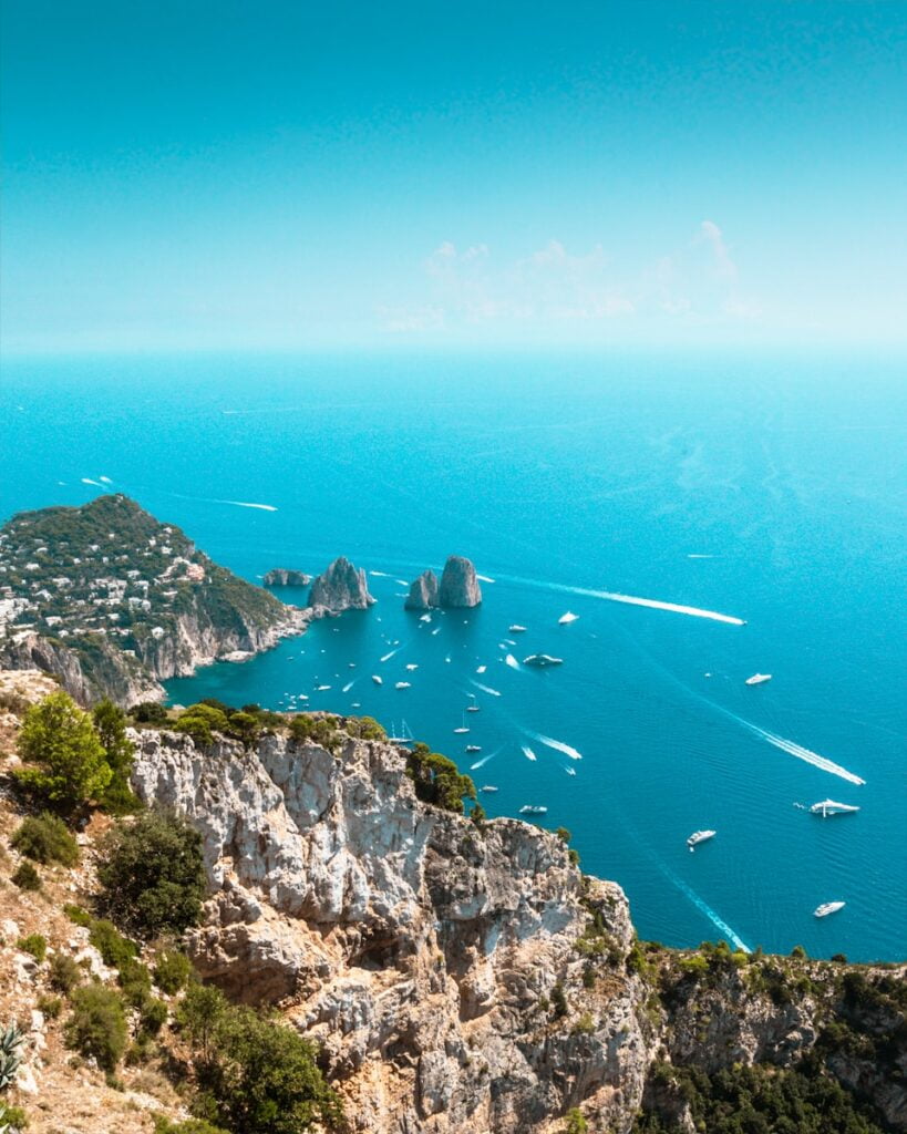 a group of boats floating on top of a large body of water