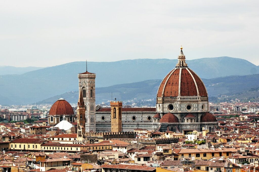 white and brown concrete dome building during daytime in Florence - Solo Travel in Italy