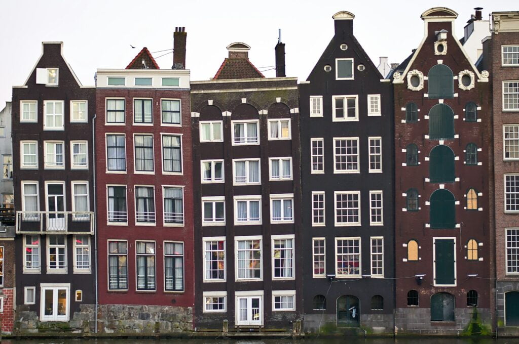 assorted-color houses under white sky in Amsterdam