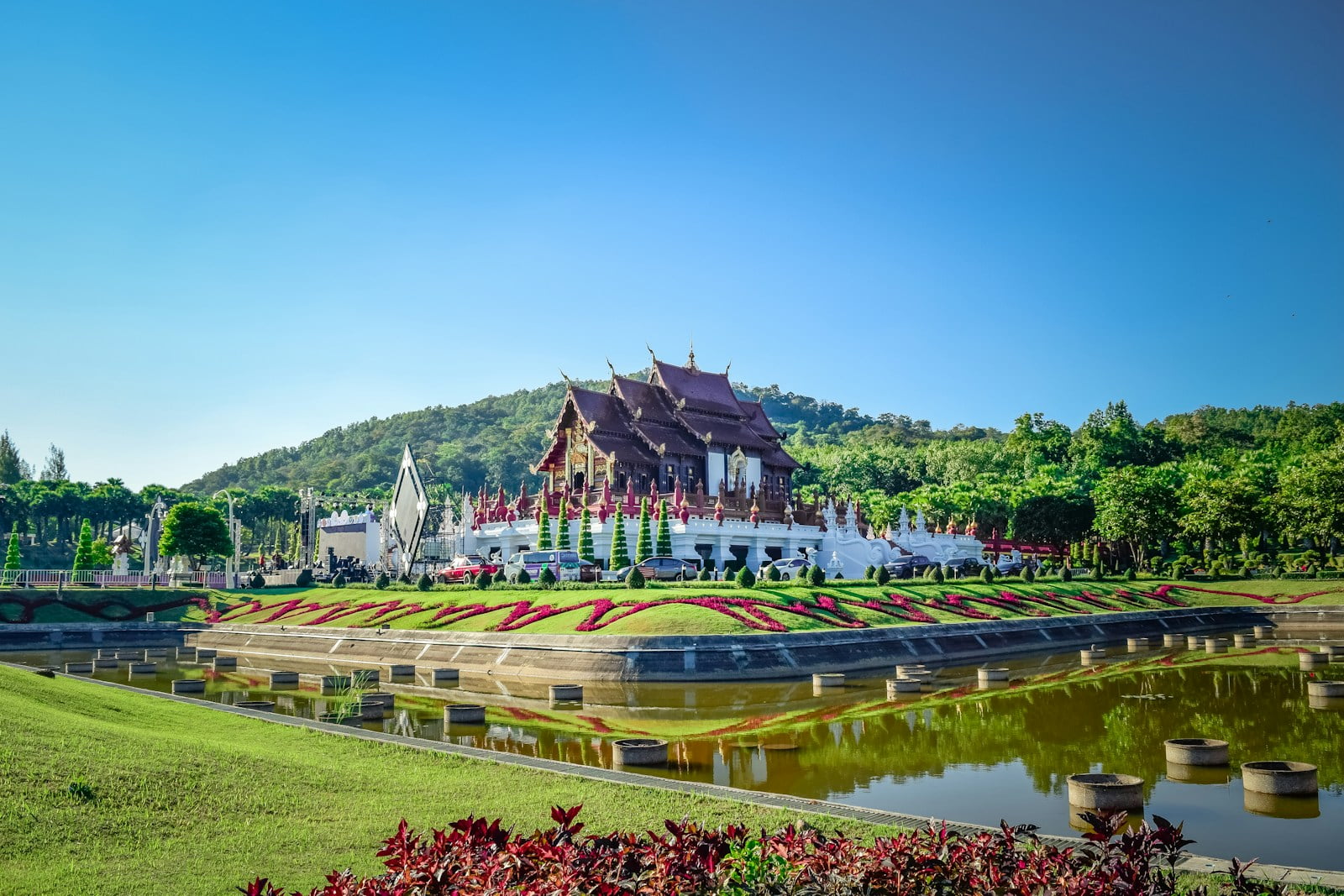 a large building sitting on top of a lush green field, Chiang Mai Travel Guide