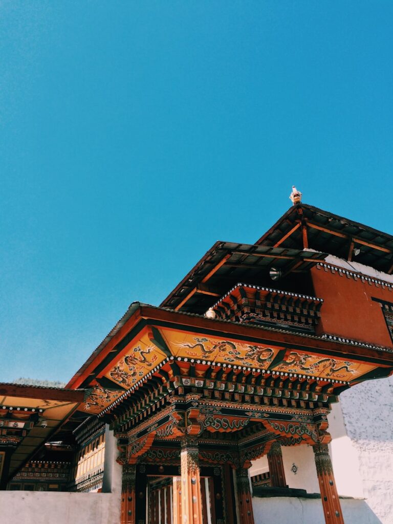 brown and black temple with clear sky, bhutan travel guide