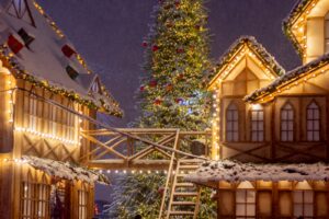 a lit up christmas tree in front of a house,best countries to visit in december