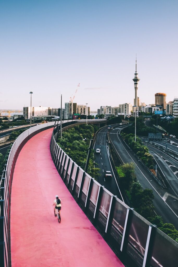 person biking on red concrete road during daytime - New Zealand is one of the best countries